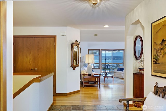hallway featuring baseboards and wood finished floors