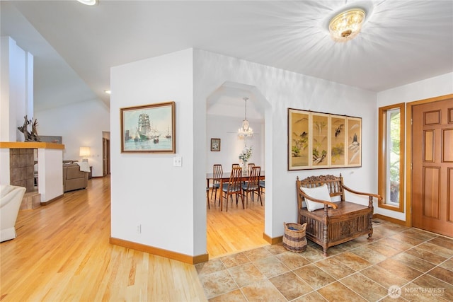 entrance foyer with recessed lighting, baseboards, a chandelier, and wood finished floors