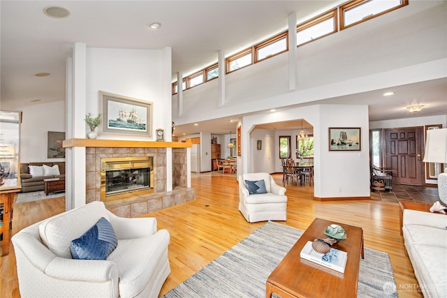 living room featuring arched walkways, wood finished floors, and a fireplace