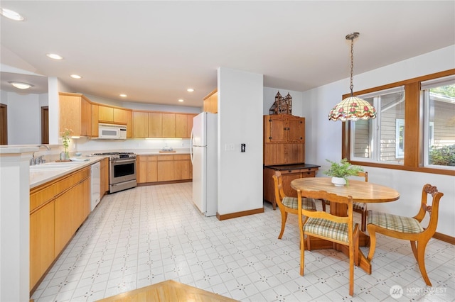 kitchen with white appliances, baseboards, light floors, light countertops, and a sink