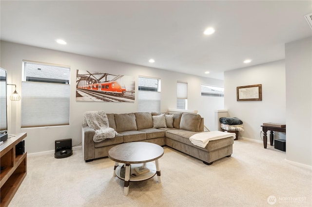 living area with baseboards, recessed lighting, and light colored carpet