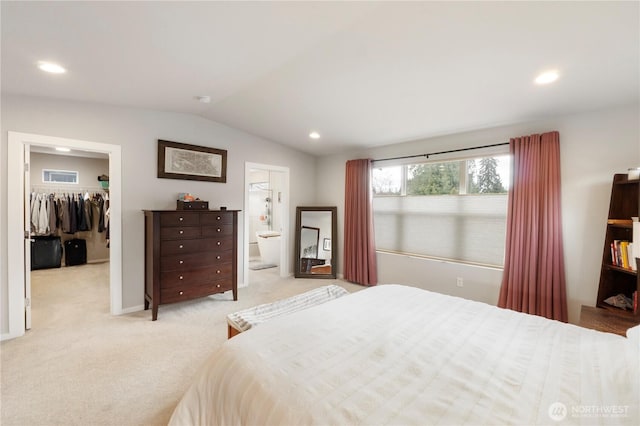 bedroom featuring recessed lighting, light carpet, a spacious closet, and vaulted ceiling