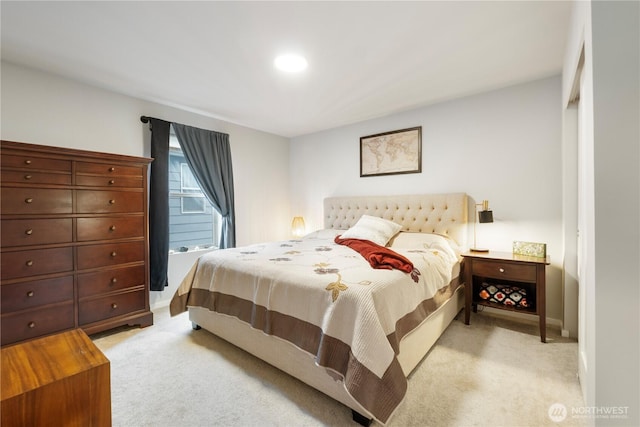 bedroom with baseboards and light carpet