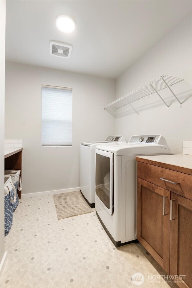 laundry room with separate washer and dryer, baseboards, visible vents, and light floors