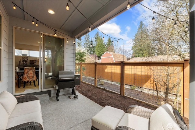 view of patio featuring fence and a grill