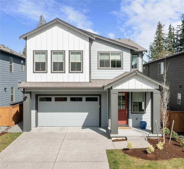 view of front facade with board and batten siding, an attached garage, fence, and concrete driveway
