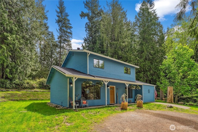 4715 NE Thunder Ln, Poulsbo, WA 98370 - view of front of house featuring covered porch, a front lawn, and driveway