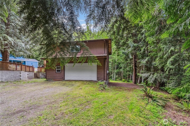 4715 NE Thunder Ln, Poulsbo, WA 98370 - view of side of home with a garage, an outbuilding, and a yard