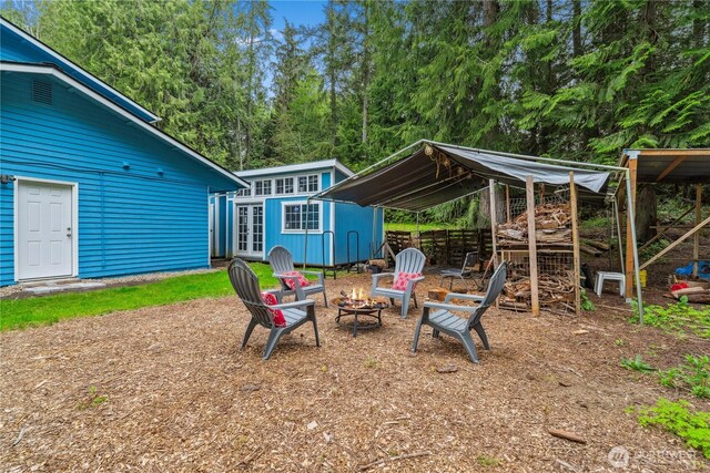4715 NE Thunder Ln, Poulsbo, WA 98370 - view of yard featuring an outdoor fire pit, an outbuilding, and french doors