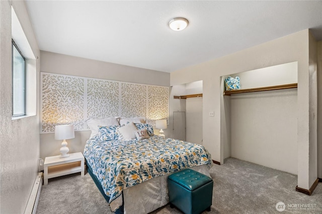 4715 NE Thunder Ln, Poulsbo, WA 98370 - carpeted bedroom featuring a baseboard heating unit and two closets