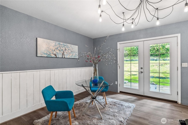 4715 NE Thunder Ln, Poulsbo, WA 98370 - living area featuring french doors, wood finished floors, a wainscoted wall, and a textured wall
