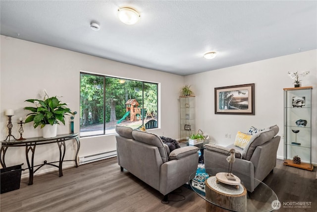 4715 NE Thunder Ln, Poulsbo, WA 98370 - living room with baseboard heating, wood finished floors, and a textured ceiling