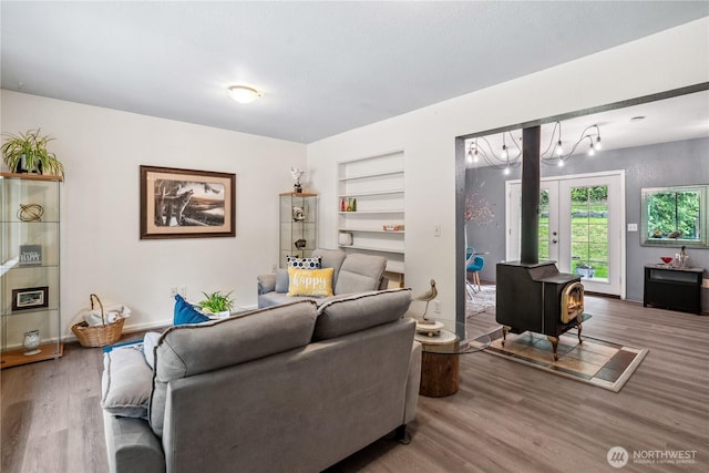 4715 NE Thunder Ln, Poulsbo, WA 98370 - living area with wood finished floors, built in features, and a wood stove