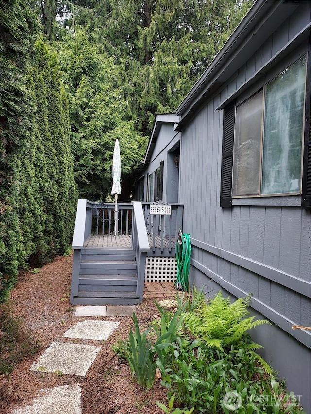 view of property exterior with a deck