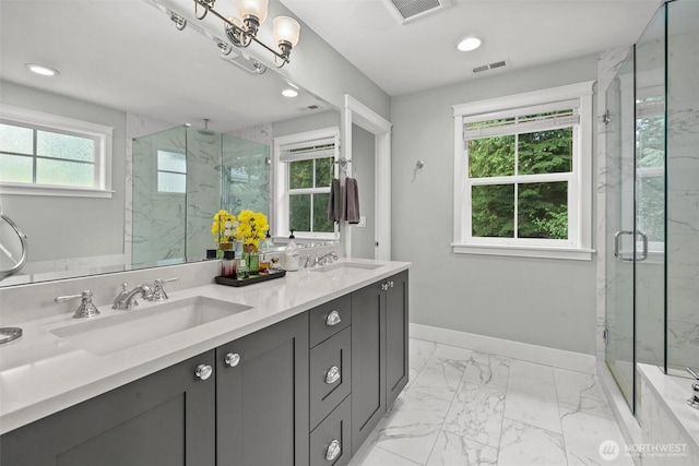 bathroom featuring visible vents, a sink, and marble finish floor