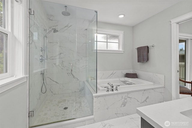full bath featuring a bath, vanity, marble finish floor, a marble finish shower, and recessed lighting