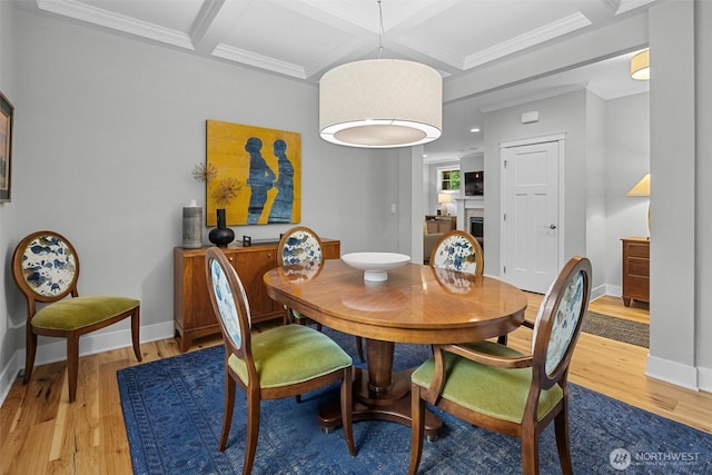 dining room with baseboards, coffered ceiling, and light wood-type flooring