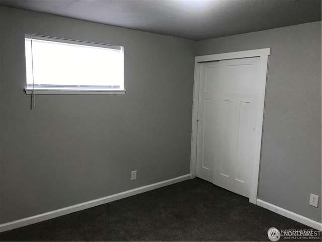 1309 Poindexter Ave Unit A-B, Bremerton, WA 98312 - unfurnished bedroom featuring dark colored carpet, baseboards, and a closet