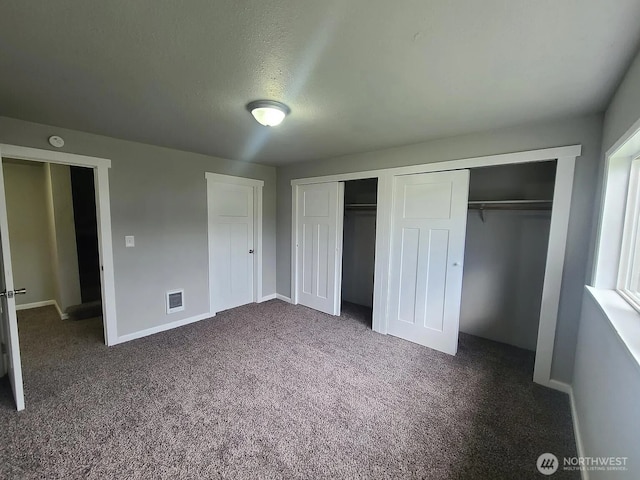 1309 Poindexter Ave Unit A-B, Bremerton, WA 98312 - unfurnished bedroom with multiple closets, dark colored carpet, and baseboards