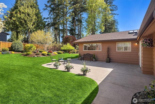 view of yard featuring fence and a patio area