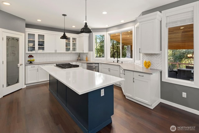 kitchen featuring backsplash, stainless steel appliances, and a wealth of natural light
