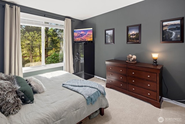 carpeted bedroom featuring baseboards