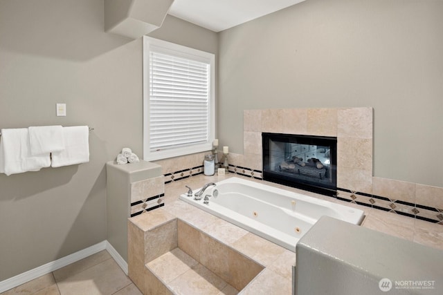 bathroom with a jetted tub, baseboards, tile patterned floors, and a tile fireplace