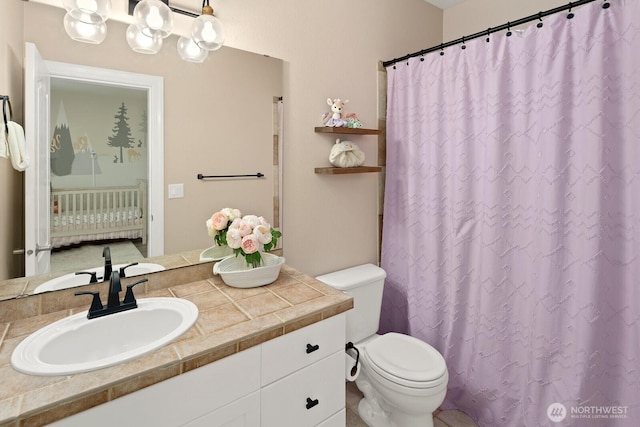 bathroom with vanity, a shower with shower curtain, and toilet