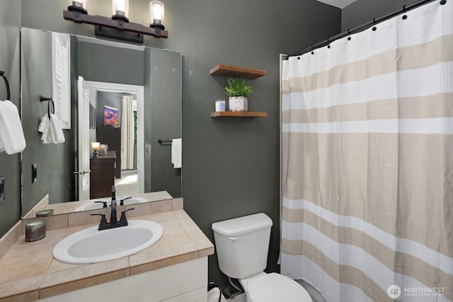 full bathroom featuring vanity, curtained shower, and toilet