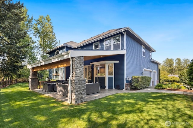 back of house featuring fence, outdoor dry bar, stone siding, a patio area, and a lawn
