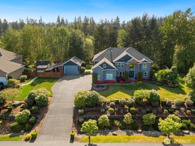 birds eye view of property with a view of trees