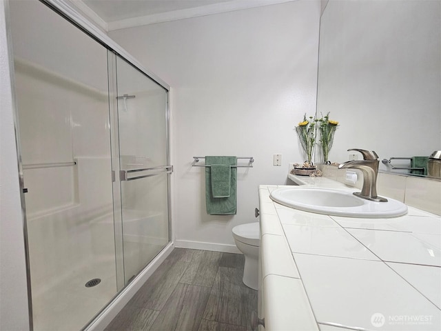 full bath featuring a stall shower, toilet, wood finished floors, and vanity