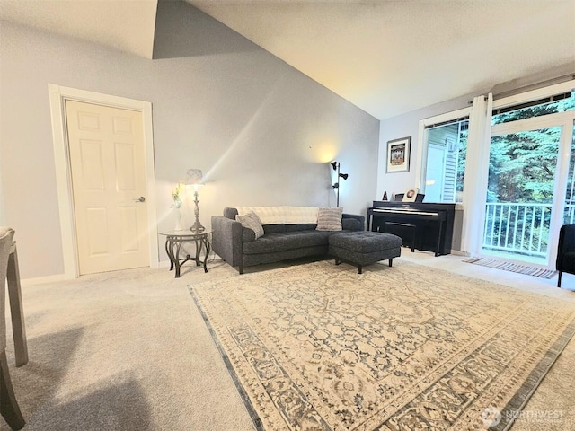 carpeted living area with lofted ceiling