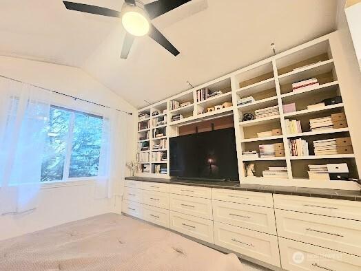 unfurnished living room featuring vaulted ceiling and ceiling fan
