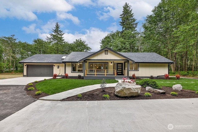 27716 114th Ave E, Graham, WA 98338 - view of front facade featuring a front lawn, covered porch, concrete driveway, and an attached garage
