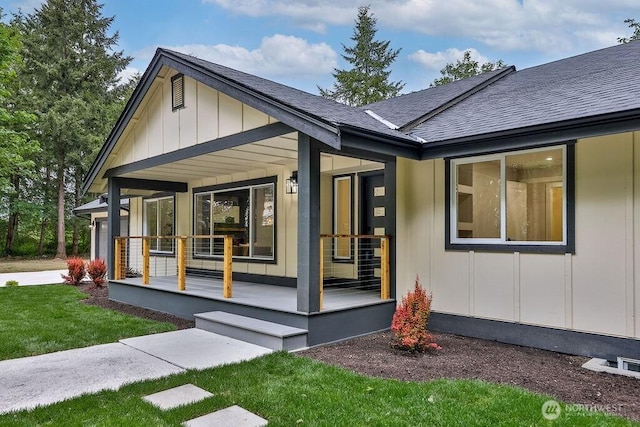 27716 114th Ave E, Graham, WA 98338 - exterior space featuring a porch, a lawn, board and batten siding, and roof with shingles