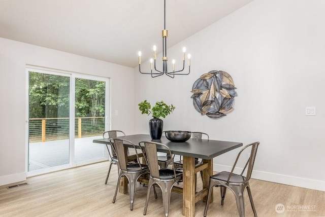 27716 114th Ave E, Graham, WA 98338 - dining space with an inviting chandelier, light wood-type flooring, visible vents, vaulted ceiling, and baseboards