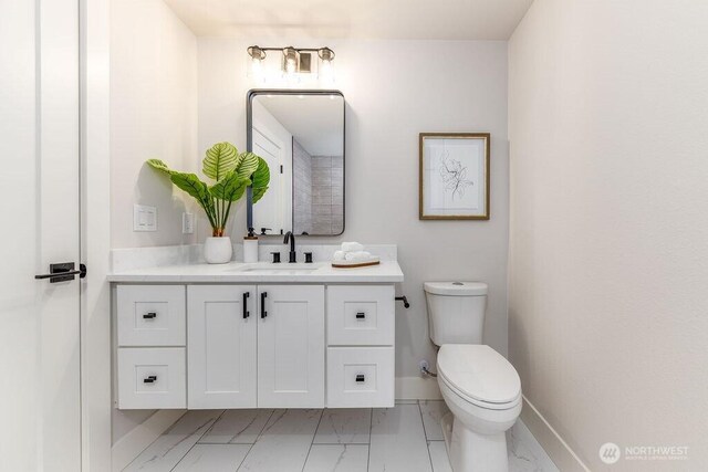 27716 114th Ave E, Graham, WA 98338 - bathroom with vanity, toilet, marble finish floor, and baseboards
