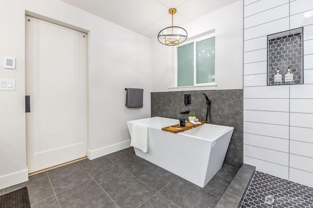27716 114th Ave E, Graham, WA 98338 - full bathroom with a soaking tub, a notable chandelier, tile patterned flooring, and baseboards