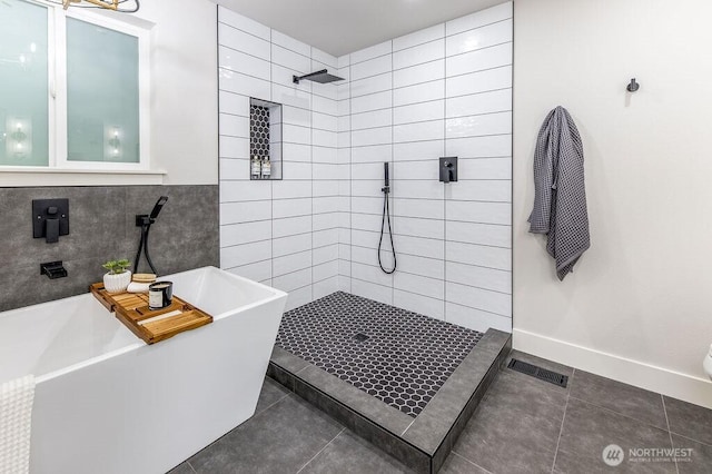 27716 114th Ave E, Graham, WA 98338 - full bathroom featuring a tile shower, visible vents, tile walls, a freestanding tub, and tile patterned flooring
