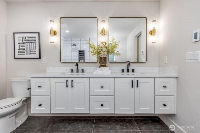 27716 114th Ave E, Graham, WA 98338 - bathroom with toilet, double vanity, a sink, and tile patterned flooring