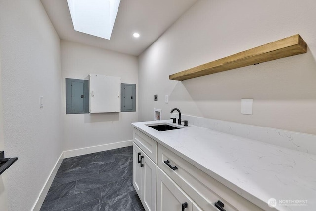 27716 114th Ave E, Graham, WA 98338 - laundry area featuring hookup for a washing machine, baseboards, electric panel, and a sink