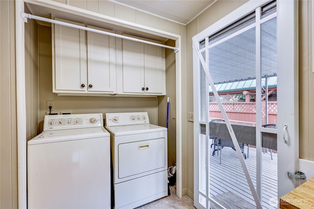 laundry room featuring crown molding, cabinet space, and washer and dryer