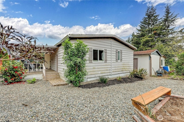 view of side of home featuring a wooden deck