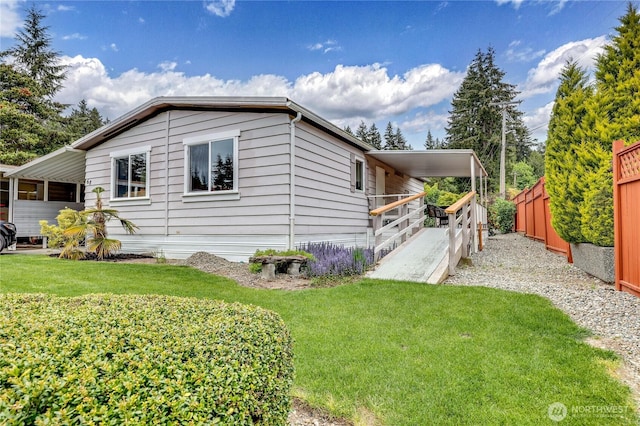 view of property exterior with fence and a lawn