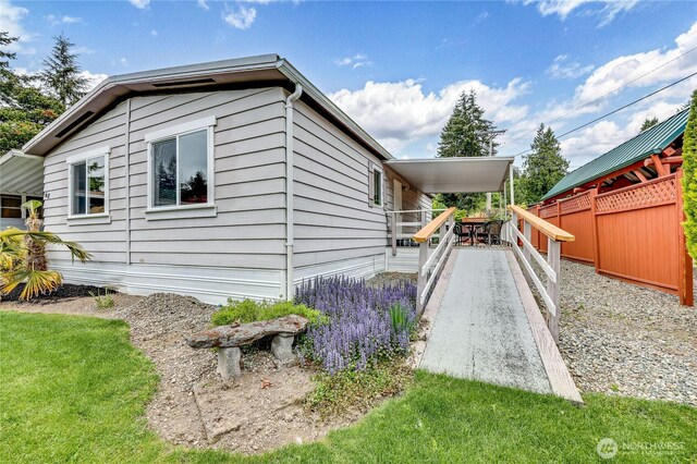view of side of home featuring fence