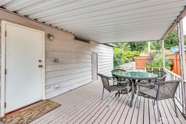 wooden terrace featuring fence and outdoor dining area