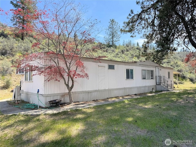 view of side of home with a lawn