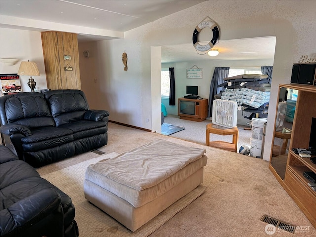 living room featuring visible vents and carpet floors