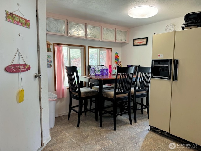 dining room with a textured ceiling